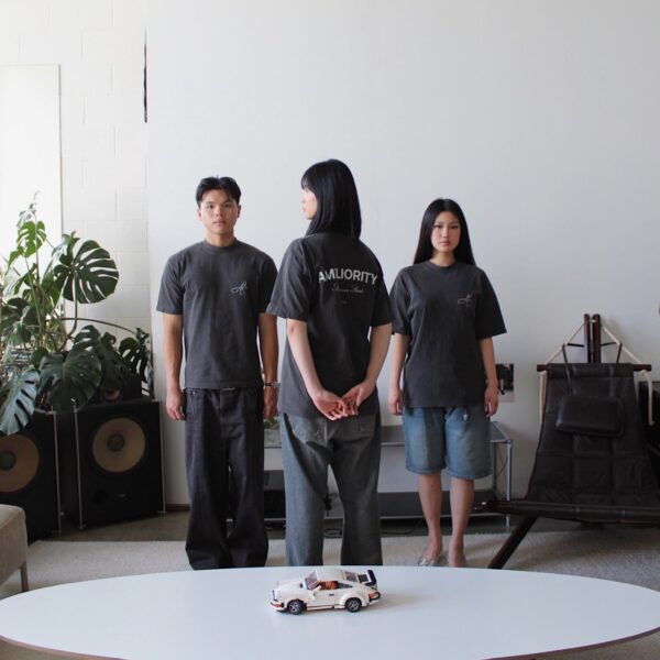 Model wearing vintage black oversized tee in minimal white room